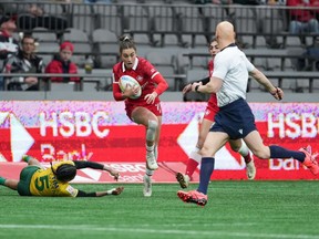Canada's Chloe Daniels, centre, gets away from Brazil's Thalia Da Silva Costa and runs the ball for a try during HSBC Canada Sevens women's rugby action, in Vancouver, B.C., Saturday, March 4, 2023.