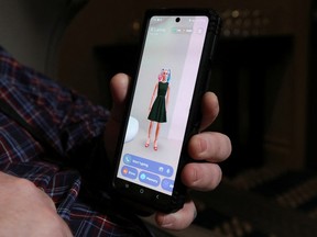 Andrew McCarroll holds his smartphone while corresponding with his Replika AI chatbot named B'Lanna, in Billings, Mont., on March 12, 2023.
