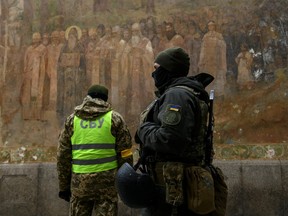 Ukrainian law enforcement officers stand next to an entrance to the Kyiv Pechersk Lavra monastery compound, amid Russia's attack on Ukraine, in Kyiv, Ukraine November 22, 2022. REUTERS/Vladyslav Musiienko