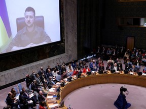 Ukrainian President Volodymyr Zelenskiy appears on a screen as he addresses the United Nations Security Council via video link during a meeting amid Russia's invasion of Ukraine.