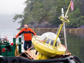 Brad Buckham of the University of Victoria's Pacific Regional Institute for Marine Energy Discovery with a buoy used to collect ocean energy data.