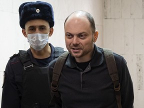 FILE - Russian opposition activist Vladimir Kara-Murza is escorted to a hearing in a court in Moscow, Russia, Feb. 8, 2023. The U.S. has imposed sanctions and visa restrictions on six Russian officials and an expert witness involved in the incarceration of Vladimir Kara-Murza, a Russian opposition leader who has been imprisoned in Moscow since April for speaking out against Russia's invasion of Ukraine. (AP Photo, File)