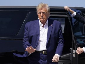 FILE - Former President Donald Trump walks to board his airplane for a trip to a campaign rally in Waco, Texas, at West Palm Beach International Airport, Saturday, March 25, 2023, in West Palm Beach, Fla.