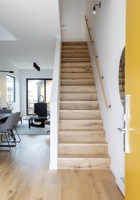 The staircase that connects the home's three levels is bright thanks to double-height vaulted ceilings.