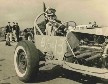 Red Robinson pretends to broadcast live from the seat of an early dragster. He was a member of the Igniters Custom Car Club of Burnaby.