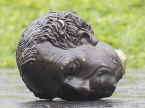The decapitated head of a statue of Sir Canada's first prime ministerJohn A. Macdonald lies on the ground following a protest in Montreal in August 2020.