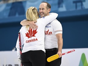 Canada's Jennifer Jones and Brent Laing hug at the World Mixed Doubles Curling Championship Gangneung, Korea on Wednesday, April 26, 2023. The husband-and-wife duo qualified for the semifinal after wrapping up first place in their pool at the world mixed doubles curling championship on Thursday.