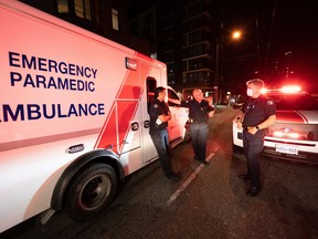 Paramedic Specialists Brian Twaites and David Hilder of B.C. Ambulance debrief after responding to a drug overdose in downtown Vancouver, Wednesday, June 23, 2021. Twaites says he has watched as the province's illicit drugs have become more toxic, requiring more effort and more overdose-reversal medication to save people's lives.