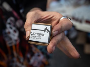 Martin Steward holds cocaine he received from the Drug User Liberation Front, which was handing out a safe supply of illicit drugs in the Downtown Eastside to mark the fifth anniversary of British Columbia declaring a public health emergency in the overdose crisis, in Vancouver, B.C., Wednesday, April 14, 2021.