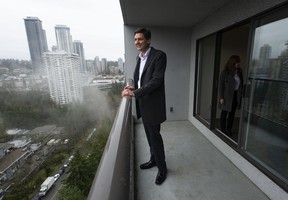 B.C. premier David Eby on the balcony of a suite at the 115 Place Housing Co-operative in Burnaby, after a rental housing announcement on Jan. 12, 2023.