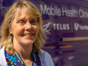 Fraser Health’s public health hygienist Helga Thordarson beside the mobile van.)