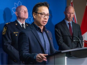 Mayor Ken Sim speaks as he is backed Wednesday by Chief Constable Adam Palmer and city manager Paul Mochrie