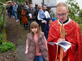 Father Mykhailo Ozorovych leads the procession of the holy shroud as part of Easter services at Holy Eucharist Cathedral in New Westminster. Many recent arrivals from Ukraine are members of the congregation at the Catholic church.