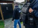 Police were on-hand as government officials went through the former Hells Angels East End clubhouse in Vancouver. The B.C. government seized the hose through a civil forfeiture order.