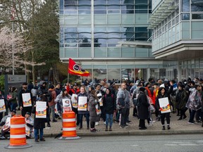 Public Service Alliance of Canada (PSAC) workers picket outside the Canada Revenue Agency building on King George Boulevard in Surrey on April 19, 2023.