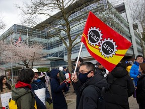 Striking workers outside the Canada Revenue Agency office in Surrey on April 19, 2023.