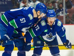 Vancouver Canucks defenceman Tyler Myers talks with Anthony Beauvillier before a face off at Rogers Arena.