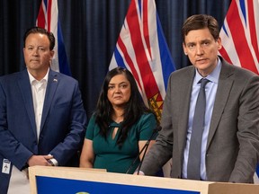 Premier David Eby speaks in front of Jim Gould, CEO of the BC Nurses Union, and Aman Grewal, President of the BC Nurses Union, at an update on nursing in British Columbia at the BC legislature press theatre in Victoria, B.C. April 4, 2023.(DARREN STONE, TIMES COLONIST).