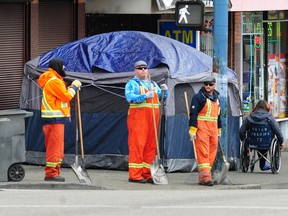 City workers clean up trash along East Hastings in the Downtown Eastside, an area with many of the tent dwellers the city intends to forcibly remove.