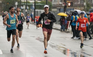 Elite runners run to the finish of the 2023 Sun Run in Vancouver on April 16, 2023.