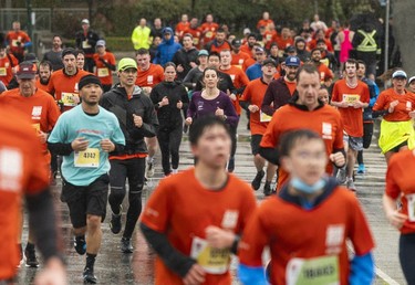 Runners run along Quebec Street and Pacific Blvd. in the 2023 Sun Run in Vancouver on April 16, 2023.