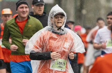 Alannah Aranui tries to stay dry in the 2023 Sun Run in Vancouver on April, 16, 2023.