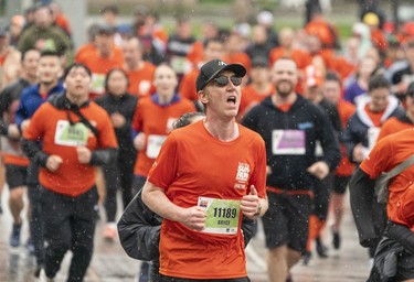 Bryce Ashdown runs along Quebec Street in the 2023 Sun Run in Vancouver on April 16, 2023.