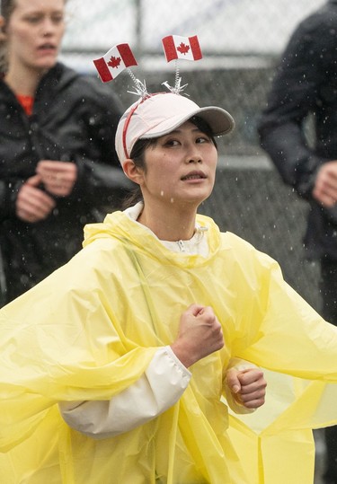 A woman shows her patriotism while running in the 2023 Sun Run in Vancouver on April 16, 2023.