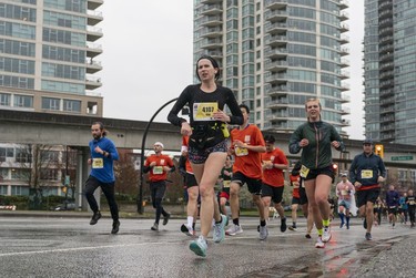 Kimberly Newton runs along Pacific Blvd during the 2023 Sun Run in Vancouver on April 16, 2023.