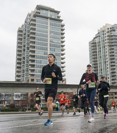 Alan Zhou runs along Pacific Blvd during the 2023 Sun Run in Vancouver on April 16, 2023.