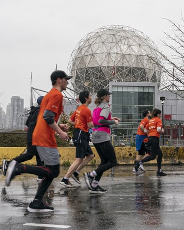 Runners run past Science World during the 2023 Sun Run in Vancouver on April 16, 2023.