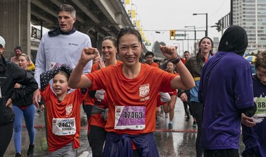 Wendy Tang crosses the finish line to complete the 2023 Sun Run in Vancouver on April 16, 2023.