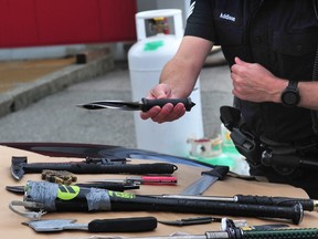 Vancouver Police Sgt Steve Addison displays a weapon seized last week.