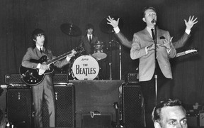 Red Robinson urges a rowdy Vancouver crowd in 1964 to settle down so the Beatles can perform.