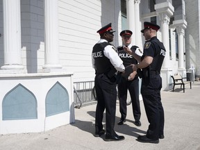 Deputy Chief Robertson Rouse of the York Regional Police (left) and Insp. Charles Byham (centre) speak with a colleague outside the Islamic Society of Markham following a news conference about an alleged hate incident in Markham, Ont. on Monday, April 10, 2023. Mosques across Canada have increasingly had to ask congregants to stay vigilant against potential attacks and harassment during the holy month of Ramadan, Muslim advocacy groups say, noting that the normalization of such security conversations is a concern.
