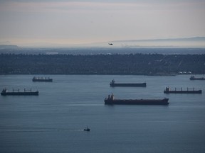 Cargo ships sit at anchor on English Bay, in Vancouver, on Thursday, Feb. 20, 2020. The federal government has announced the approval of a container port expansion project at Roberts Bank, south of Vancouver.THE CANADIAN PRESS/Darryl Dyck