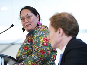 Aluki Kotierk, president of Nunavut Tunngavik Inc., looks towards Marc Miller, Minister of Crown–Indigenous Relations, as they make an announcement, in Ottawa, Tuesday, Feb. 28, 2023. The organization responsible for enrolling Inuit under the Nunavut agreement says it has removed twin sisters from its enrolment list.