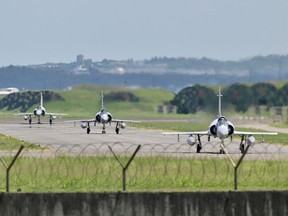 French-made Mirage 2000 fighter jets taxi on a runway in front of a hangar at the Hsinchu Air Base in northwestern Taiwan. China has been conducting military exercises around Taiwanese air space almost daily for months.