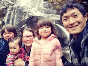 Davis and Riina Lim with their three daughters. The couple are dealing with their one-year-old son Theo's rare genetic disorder, and objected to him getting a tracheostomy as part of his care.