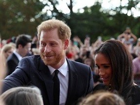 Britain's Prince Harry and Meghan, the Duchess of Sussex, greet people as they walk outside Windsor Castle, following the passing of Britain's Queen Elizabeth, in Windsor, Britain, September 10, 2022.
