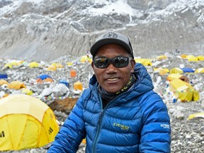 In this file photo taken on May 2, 2021, Nepal mountaineer Kami Rita Sherpa poses for a picture at the base camp in the Mount Everest region.
