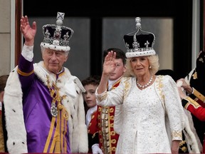 King Charles III and Queen Camilla wave from The Buckingham Palace balcony during the Coronation of King Charles III and Queen Camilla on May 06, 2023 in London, England.