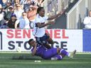 May 24, 2023; Langford, British Columbia, CAN; Pacific FC midfielder Cedric Toussaint (28) slides into Vancouver Whitecaps FC defender Ali Ahmed (22) during the first half at Starlight Stadium. Mandatory Credit: Anne-Marie Sorvin-USA TODAY Sports