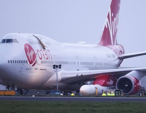 Cosmic Girl, a Virgin Boeing 747-400 aircraft sits on the tarmac with Virgin Orbit's LauncherOne rocket attached to the wing, ahead of the first UK launch at Spaceport Cornwall at Newquay Airport in Newquay, Britain, January 9, 2023.