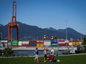 A man drinks a beer at Crab Park in Vancouver, on Saturday, May 13, 2023. Flood and fire risks in B.C.'s interior continue as unseasonably hot weather gripped much of the province this weekend, as some hard-hit communities grapple with potential evacuations and clean-up efforts from earlier weather events.