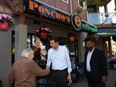 Premier David Eby and BC NDP candidate Ravi Parmar walk along Goldstream Ave. as they visit shops and talk to locals while out in Langford, B.C., on Thursday, May 25, 2023.