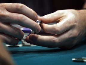 Everyone who enters a British Columbia casino will soon be required to present government-issued identification, in what the BC Lottery Corporation says is an initiative to support people who have registered for self-exclusion. A poker player twirls his chips while playing his hand during a game at a poker championship in Calgary, Wednesday, Aug. 25, 2010.