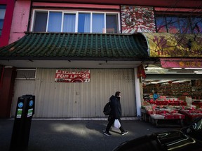A pedestrian walks past a retail space for lease in Chinatown in Vancouver on Tuesday, March 28, 2023. Vancouver's Chinatown is getting a $2.2-million provincial grant to revitalize the historic neighbourhood.