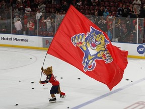 Florida Panthers mascot skates with the club banner.