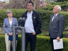 Chief Harley Chingee of B.C.'s McLeod Lake Indian Band talks to media in Victoria, B.C., Wednesday, May 3, 2023, as Indigenous Relations and Reconciliation Minister Murray Rankin and Josie Osborne, energy, mines and low carbon innovation minister, look on.